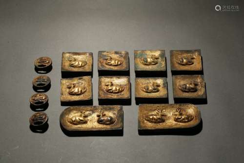 A set of fourteen gilt bronze belt plaques