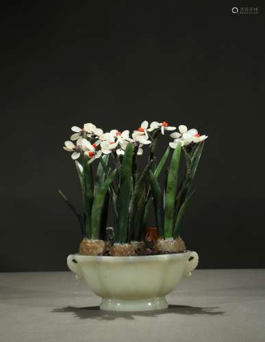 A white jade planter with green jade orchids