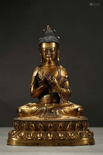 A gilt-bronze figure of buddha with snake