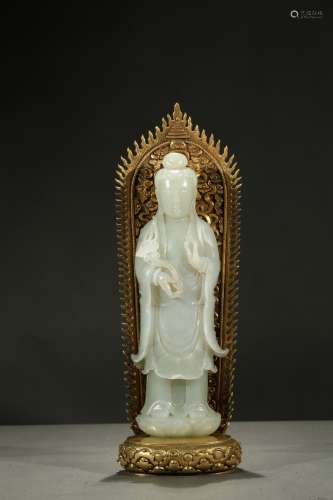 A white jade Guanyin with gilt bronze backsplat