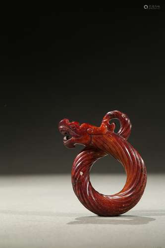 A red jade knotted dragon pendant