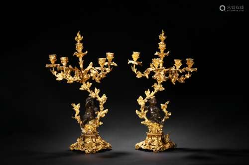 A pair of large European gilt candlesticks