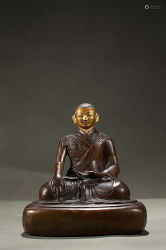 A copper alloy figure of cold-gilded lama