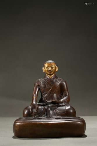 A copper alloy figure of cold-gilded lama