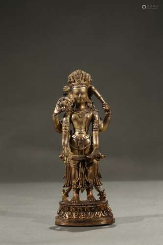 A gilt-bronze figure of standing deity