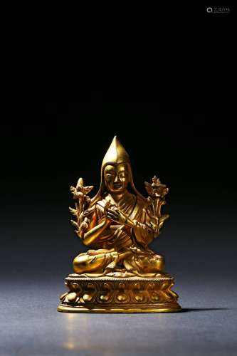 A gilt-bronze figure of guru