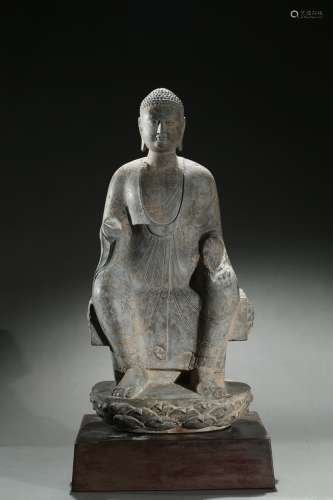 A stone carving of seated shakyamuni