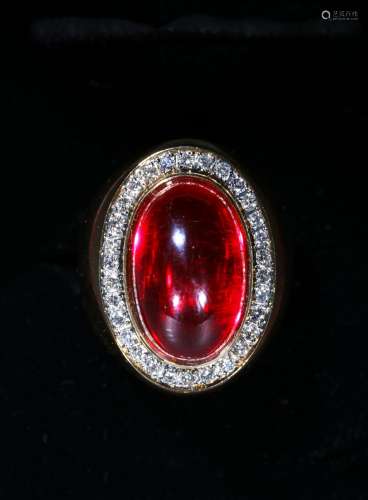 A red gem and diamond gold ring