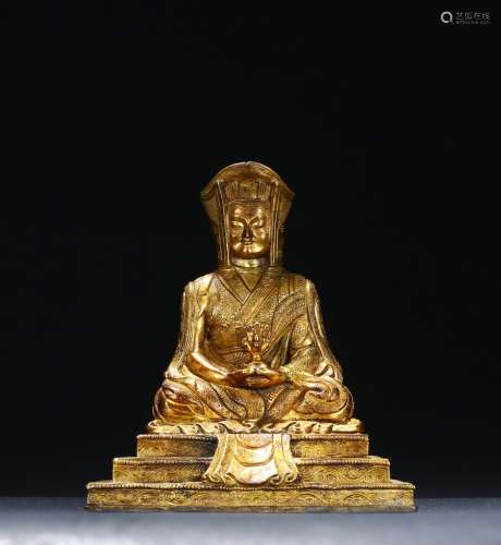 A gilt-bronze of seated guru