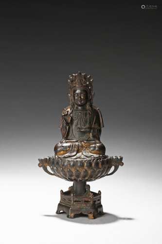 A parcel-gilt shakyamuni on lotus figure