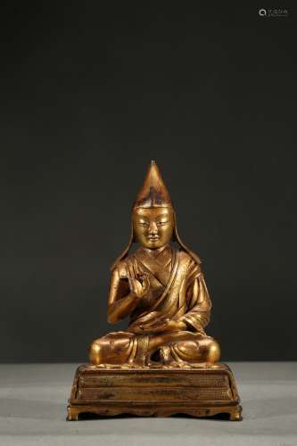 A gilt-bronze figure of lama