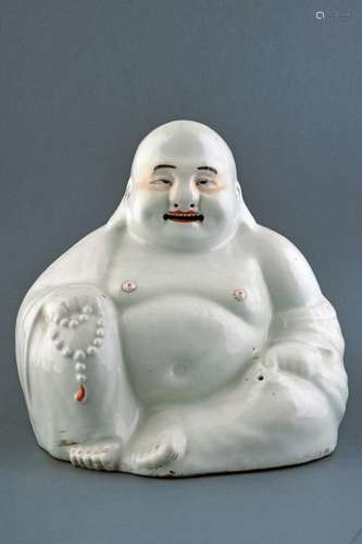 A PORCELAIN SEATED BUDDHA