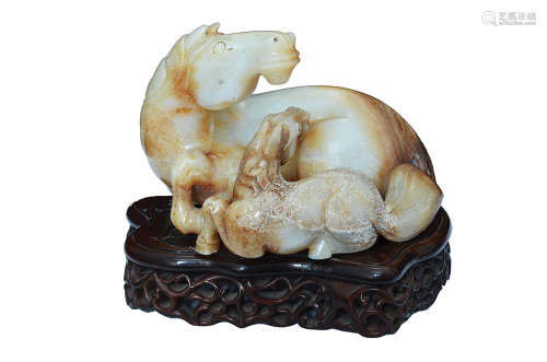 A WHITE RUSSET JADE CARVING OF A HORSE AND FOAL