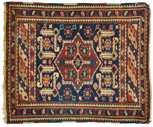 AN ANTIQUE CAUCASIAN RUG