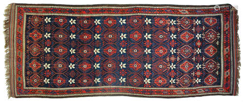 AN ANTIQUE BALUCH PERSIAN RUG