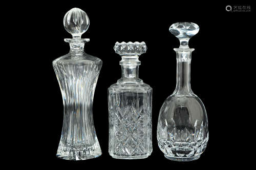 THREE GLASS AND CRYSTAL DECANTER AND STOPPERS