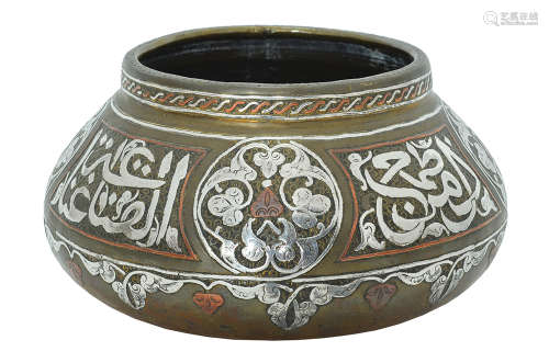 AN ISLAMIC SILVER AND COPPER INLAID BRASS BOWL