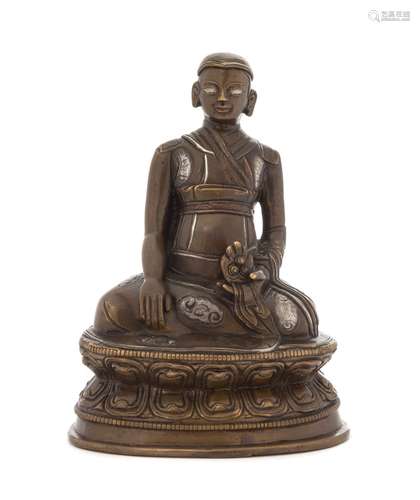 A Tibetan Silver Inlaid Bronze Figure of a Lama