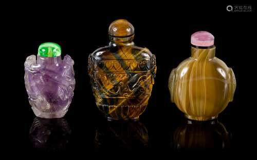 Three Carved Hardstone Snuff Bottles