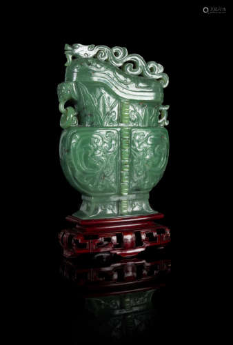 A Carved Spinach Jade Covered Vase Height of the vessel 7 inches.