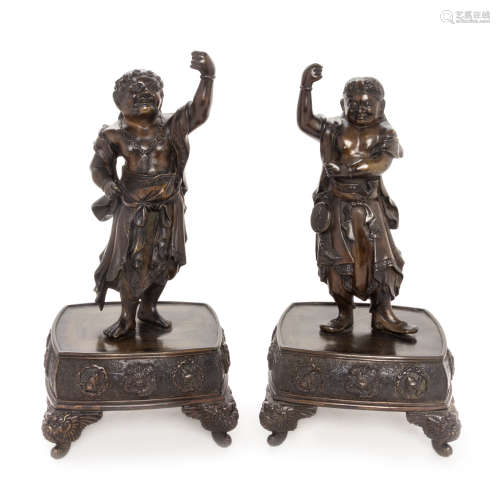 A Pair of Bronze Guardian-Form Candle Holders