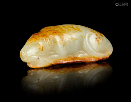 A Carved White and Russet Jade Figure of a Dog