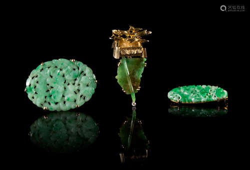 Three Jadeite and Yellow Gold Mounted Brooches Length of largest 1 3/4 inches.