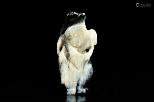 BLACK AND WHITE JADE CLEVERLY CARVED 'BOY' ORNAMENT