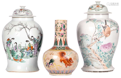 A Chinese bottle vase, overall polychrome decorated  with Fu lions, marked, about 1900; added two Chinese famille rose decorated vases and covers with figures, a bird on a flower branch and calligraphic texts, one vase marked, H 34 - 44 cm