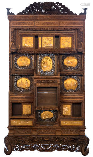 A rare Japanese late Meiji period carved hardwood cabinet, the door panels and the roundels decorated with gilt lacquer, set with ivory, tinted and coloured ivory and mother of pearl, H 332,5 - W 180 - D 52 cm