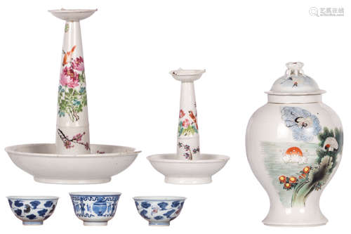 Two Chinese famille rose and polychrome oil lamp stands and a vase and cover with birds on flower branches and calligraphic texts; added three Chinese blue and white and iron red decorated cups, Qianlong marked, H 19 - 30 - ø 9,5 cm