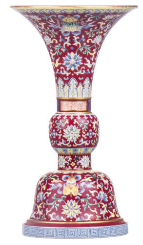 A Chinese red ground polychrome floral decorated Gu vase with auspicious symbols and meandering friezes, with a Qianlong mark, H 27,5 cm