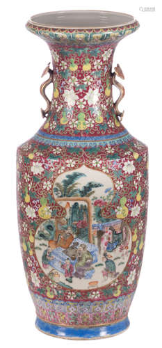 A Chinese pink ground floral decorated vase, the roundels famille rose with animated scenes, the handles ruyi shaped, Qianlong marked, 19thC, H 60,5 cm