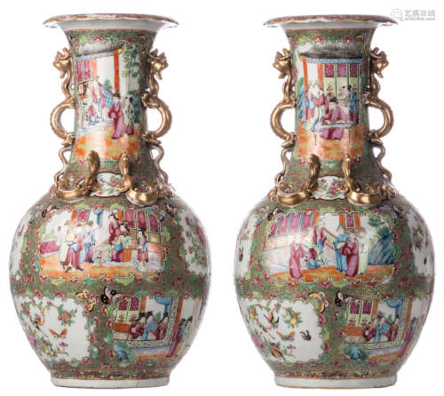 A pair of Chinese Canton famille rose bottle vases, floral and dragon relief decorated, the roundels with court scenes, birds and flower branches, about 1900, H 43 cm