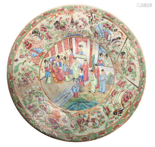 A Chinese celadon famille rose floral relief decorated plate with a court scene, flower branches, birds and antiquities, 19thC, ø 41 cm