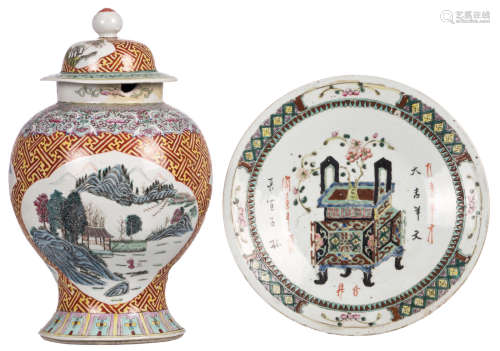 A Chinese polychrome decorated vase and cover, the roundels famille rose, with figures in a mountainous river landscape, 19thC; added a Chinese polychrome decorated plate with a flower basket and calligraphic texts, H 43 - ø 34,5 cm