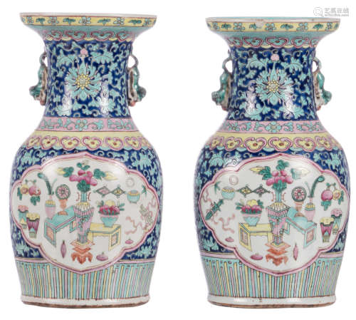 A pair of Chinese blue ground floral decorated vases, the roundels with flower vases and antiquities, 19thC, H 33,5 cm