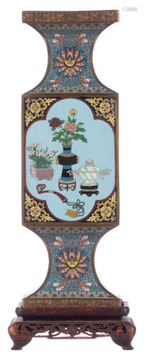 A Chinese quadrangular cloisonné vase, the roundels decorated with antiquities, flower vases and the attributes of the literate, neck and foot with floral decoration, on a matching wooden stand, H 38 (without base) - 43,5 cm (with base)