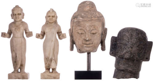 A lot: two Indian statues in white marble, H 39,5 - 41 cm; a mounted sandstone Buddha head, H 28 (without mount) - 43,5 cm (with mount); a grey stone three dimensional mask, H 30 cm