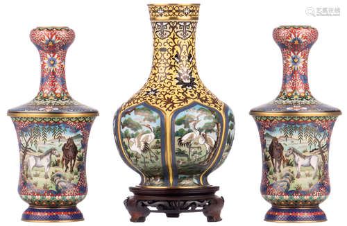 A Chinese floral decorated cloisonné bottle vase, the roundels with cranes, on a matching wooden stand; added a pair of ditto vases, the roundels decorated with horses, H 25 - 26 cm