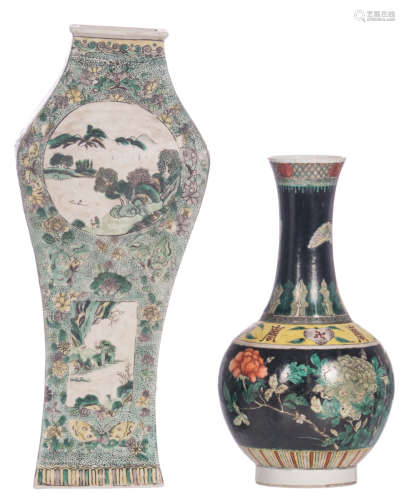 A Chinese famille noire bottle vase, decorated with flowers, butterflies and auspicious symbols, 19thC, H 33 cm; added a Chinese famille verte floral decorated quadrangular baluster shaped vase, the roundels with river landscapes, H 45,5 cm