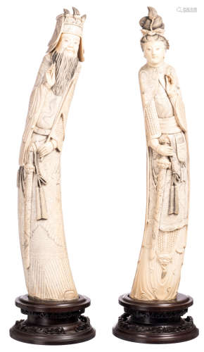 A pair of Chinese ivory carved figures depicting dignitaries, marked, first half of the 20thC, on a wooden stand, H 80 - 81 cm - Weight: about 6,9 - 7,6 (without stand) - 8,8 - 8,8kg (with stand)