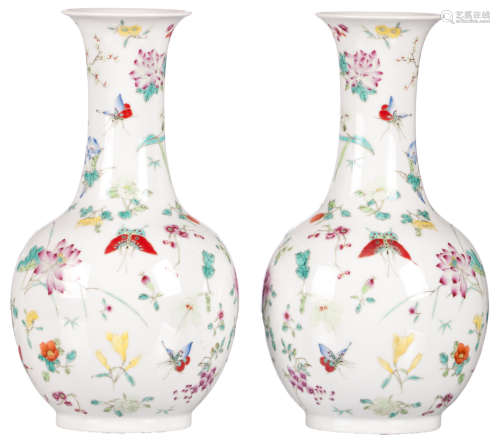 A pair of Chinese famille rose decorated bottle vases with flowers and butterflies, marked, H 36 cm