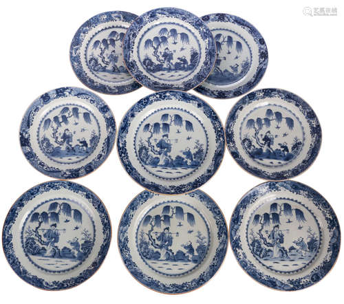 Nine Chinese blue and white decorated dishes with a lady and a servant in a garden, Kangxi and period, ø 28 - 31,5 cm