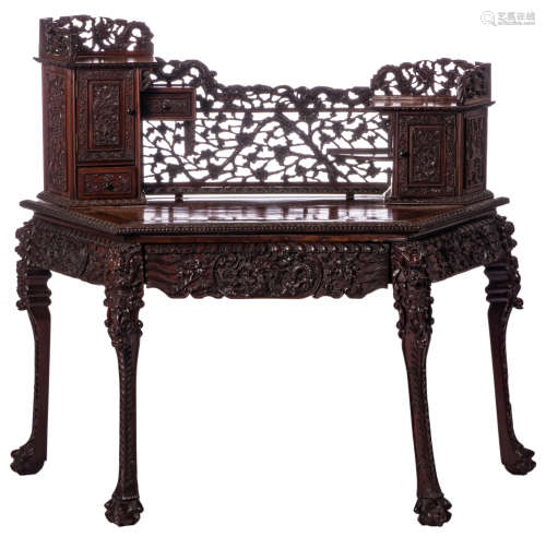 A Chinese hardwood curved writing desk, richly carved with dragons and flower branches, H 144 - W 139 - D 70 cm