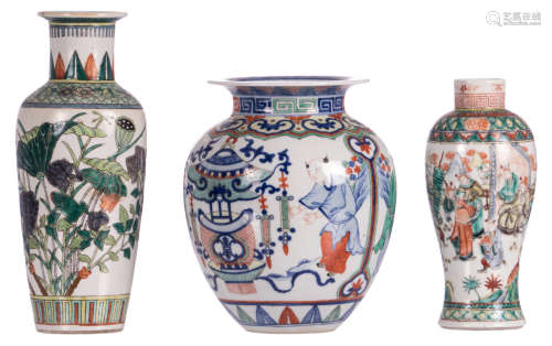 A Chinese wucai vase, overall decorated with figures and auspicious symbols, with a Wanli mark, H 24,5 cm; added two Chinese famille verte vases, one floral decorated and one with a gallant scene, H 24,5 - 30,5 cm