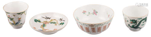 A Chinese polychrome cup and saucer, decorated with animals and a pine tree, marked; added a Chinese famille rose floral decorated bowl with auspicious symbols, marked; extra added a Chinese polychrome dragon decorated cup, marked Daoguang, H 3 - 7,5 cm