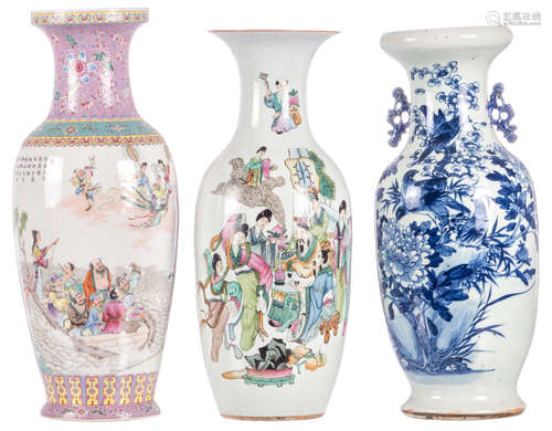 Two Chinese famille rose decorated vases with an animated scene, one vase marked, one vase with calligraphic texts; added a Chinese blue and white decorated vase with birds on a flower branch, H 58,5 - 62 cm