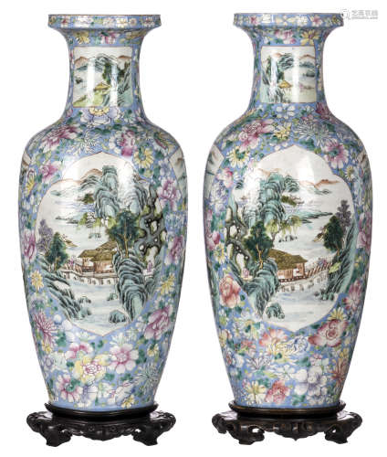 A fine pair of Chinese blue ground and floral famille rose decorated vases, the roundels depicting figures in a mountainous landscape, marked Qianlong, on matching wooden bases, H 65 (with base) - H 60 cm (without base)