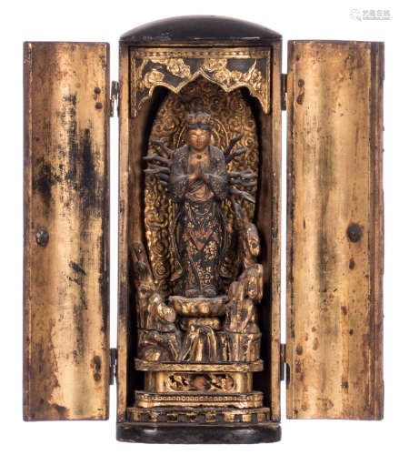 A Japanese altar in black and gold lacquer, a standing Buddha with radius on the inside, sculptured wood, Edo period, H 23,5 cm